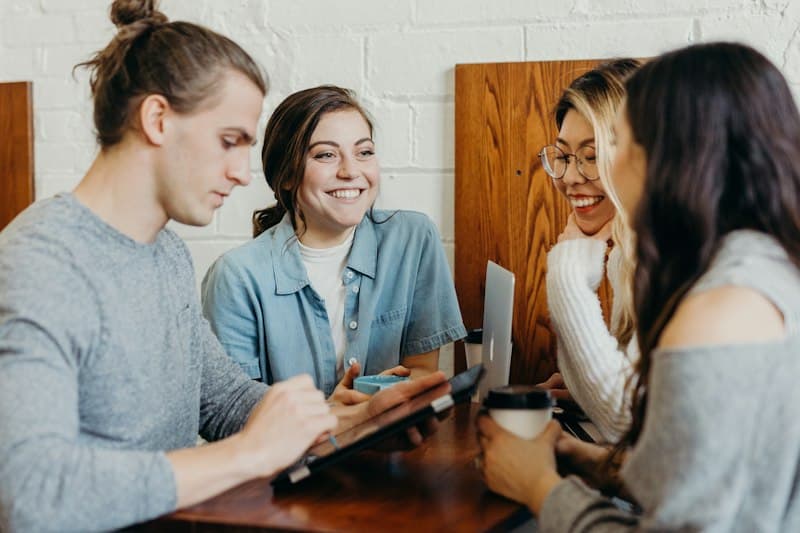 Friends smiling and talking together at a cafe